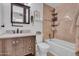 Well-lit bathroom featuring a vanity with a marble countertop, a toilet, and a bathtub-shower combination at 14446 N 40Th Pl, Phoenix, AZ 85032