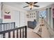 Comfortable bedroom with a crib, modern furniture, and natural light from the window, perfect for a room at 14446 N 40Th Pl, Phoenix, AZ 85032