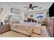 Cozy main bedroom with a decorative headboard, fan, and a comfortable sitting area at 14446 N 40Th Pl, Phoenix, AZ 85032