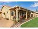 Covered outdoor patio with tile flooring, comfy seating, and beautiful desert plants at 1453 E Butler Cir, Chandler, AZ 85225