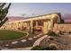 Inviting covered patio with desert landscaping, rock garden, walkway, and lush green grass at 1453 E Butler Cir, Chandler, AZ 85225