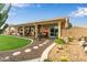 Covered patio with stepping stone path, desert landscaping, and ample seating for entertaining at 1453 E Butler Cir, Chandler, AZ 85225