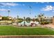 Tranquil waterfront backyard with lush landscaping, mature trees, and a private lake at 1453 E Butler Cir, Chandler, AZ 85225