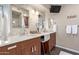 Elegant bathroom featuring dual sinks, a large mirror, and modern fixtures at 1453 E Butler Cir, Chandler, AZ 85225