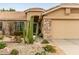 Welcoming front entrance with desert landscaping, charming stone accents, and an inviting front door at 1453 E Butler Cir, Chandler, AZ 85225