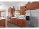 Well-equipped kitchen with wooden cabinets, stainless steel appliances, and tiled backsplash at 1453 E Butler Cir, Chandler, AZ 85225