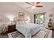 Inviting main bedroom with king bed, ceiling fan, and sliding glass door to patio at 1453 E Butler Cir, Chandler, AZ 85225