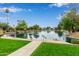 Scenic community pond with fountain and walking path surrounded by lush landscaping at 1453 E Butler Cir, Chandler, AZ 85225