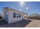 The backyard features the rear facade of the home, covered patio, and block wall at 15580 S 181St Ln, Goodyear, AZ 85338