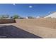 The backyard is enclosed by a block wall and has an open dirt area at 15580 S 181St Ln, Goodyear, AZ 85338