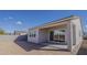 A backyard features a covered patio, rear facade of the home, and a block wall at 15580 S 181St Ln, Goodyear, AZ 85338