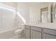 Bright bathroom featuring a tub/shower combo, white vanity with gray cabinets, and tile flooring at 15580 S 181St Ln, Goodyear, AZ 85338