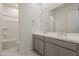 Bright bathroom featuring double sinks, white countertops, and a shower and tub combo at 15580 S 181St Ln, Goodyear, AZ 85338