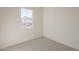 Cozy bedroom featuring light-colored walls, carpet flooring, and a window offering natural light at 15580 S 181St Ln, Goodyear, AZ 85338