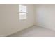 Cozy bedroom with light-colored walls, carpet floors, and a window offering natural light at 15580 S 181St Ln, Goodyear, AZ 85338