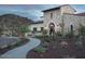 Stunning stone home featuring a large arched doorway and desert landscaping at 15580 S 181St Ln, Goodyear, AZ 85338