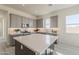 Well-designed kitchen features a large island, granite countertops, and recessed lighting at 15580 S 181St Ln, Goodyear, AZ 85338