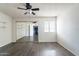 This bedroom features a large mirror sliding closet door, hardwood floors, and a ceiling fan at 16402 N 31St St # 115, Phoenix, AZ 85032