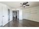 Bedroom featuring hardwood floors, ceiling fan, closet and doors to the bathroom and hallway at 16402 N 31St St # 115, Phoenix, AZ 85032