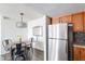 Dining area with modern lighting fixture, and stainless steel appliances nearby at 16402 N 31St St # 115, Phoenix, AZ 85032