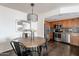 Charming dining area with a round wood table and modern lighting at 16402 N 31St St # 115, Phoenix, AZ 85032