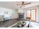 Cozy living room featuring a stone fireplace, wood-look floors, and a glass panel patio door at 16402 N 31St St # 115, Phoenix, AZ 85032