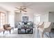 Inviting living room featuring a comfortable sofa, stylish chairs, and a ceiling fan at 16402 N 31St St # 115, Phoenix, AZ 85032