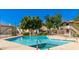 Community pool with blue tiled water, green landscaping and residential buildings in the background at 16402 N 31St St # 115, Phoenix, AZ 85032