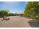 Beautiful backyard with mature trees, a barrel cactus, and low-maintenance gravel at 16413 N Orchard Hills Dr, Sun City, AZ 85351