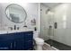 Modern bathroom featuring a blue vanity, updated fixtures, and a glass-enclosed shower at 16413 N Orchard Hills Dr, Sun City, AZ 85351