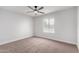 Neutral bedroom with a ceiling fan and bright window providing natural light at 16413 N Orchard Hills Dr, Sun City, AZ 85351