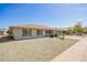 Lovely house with a well-maintained gravel front yard, palm tree, and a clear blue sky at 16413 N Orchard Hills Dr, Sun City, AZ 85351