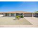 Charming single-story home featuring a gravel yard, desert landscaping, and attached two-car garage at 16413 N Orchard Hills Dr, Sun City, AZ 85351