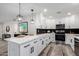 Modern kitchen showcasing white cabinetry, a quartz countertop, and stainless steel appliances at 16413 N Orchard Hills Dr, Sun City, AZ 85351