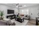 Bright living room with neutral colors, a ceiling fan, and plush furnishings at 16413 N Orchard Hills Dr, Sun City, AZ 85351