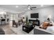 Inviting living room featuring stylish seating, a modern ceiling fan, and an open floor plan at 16413 N Orchard Hills Dr, Sun City, AZ 85351