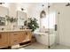 Bright bathroom featuring a double sink vanity, a soaking tub and a frameless glass shower at 16634 N 33Rd Way, Phoenix, AZ 85032