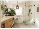 Well-lit bathroom with double vanity, freestanding tub, and glass-enclosed shower with bench at 16634 N 33Rd Way, Phoenix, AZ 85032