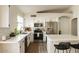 Bright kitchen with white cabinets, stainless steel appliances, and an island with seating at 16634 N 33Rd Way, Phoenix, AZ 85032