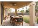 Covered patio with an outdoor dining set and backyard views with string lights above at 16634 N 33Rd Way, Phoenix, AZ 85032