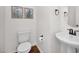 Clean powder room with pedestal sink, modern fixtures, and decorative artwork at 16875 N 12Th St # 24, Phoenix, AZ 85022