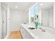 Bright bathroom with double sink vanity, walk-in shower, and a large window at 16875 N 12Th St # 3, Phoenix, AZ 85022