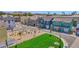 New home community featuring colorful homes, common green space, seating, and landscaped areas with young shade trees at 16875 N 12Th St # 3, Phoenix, AZ 85022