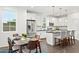 Eat-in kitchen features white cabinetry, stainless appliances, a dining table, and island seating at 16875 N 12Th St # 3, Phoenix, AZ 85022