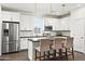 Modern kitchen features stainless steel appliances, white cabinetry, and a stylish island with bar stool seating at 16875 N 12Th St # 3, Phoenix, AZ 85022