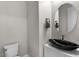 Powder room featuring a black vessel sink, a modern faucet, and decorative hand towels at 16945 W Vernon Ave, Goodyear, AZ 85395