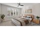 Comfortable bedroom featuring a ceiling fan, plantation shutters, and neutral decor at 16945 W Vernon Ave, Goodyear, AZ 85395