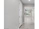 Neutral-toned hallway with wood-look tile flooring at 16945 W Vernon Ave, Goodyear, AZ 85395