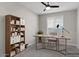 Home office with a ceiling fan, a desk, and a bookshelf at 16945 W Vernon Ave, Goodyear, AZ 85395