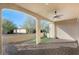 Spacious outdoor patio featuring neutral colored stone walls, brick flooring, and shaded seating area at 16945 W Vernon Ave, Goodyear, AZ 85395